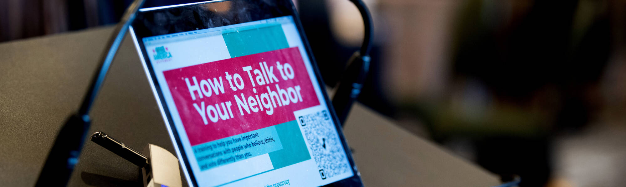 A laptop screen open to a presentation that says "How to Talk to Your Neighbor"